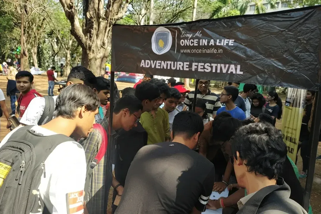 Guests at the OnceInALife Adventure Festival registration tent