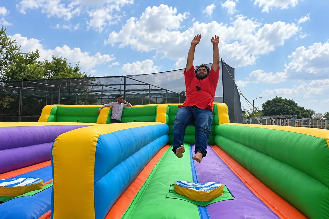 Man pulled back by a bungee cord on an inflatable bungee run