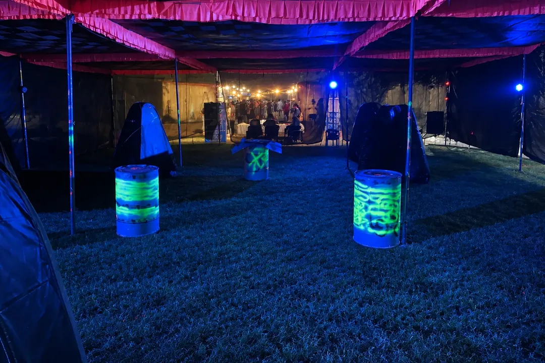 Gel blaster arena under blue lights with neon barrels