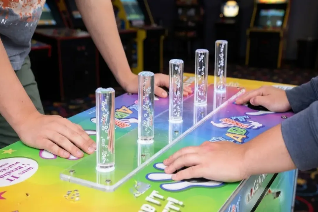 Hands ready to grab the falling sticks in a grab the stick reflex game