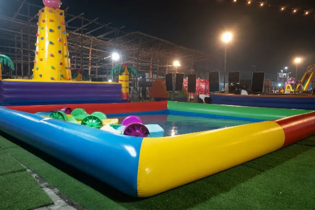 Inflatable water pool with play balls at a night-time event