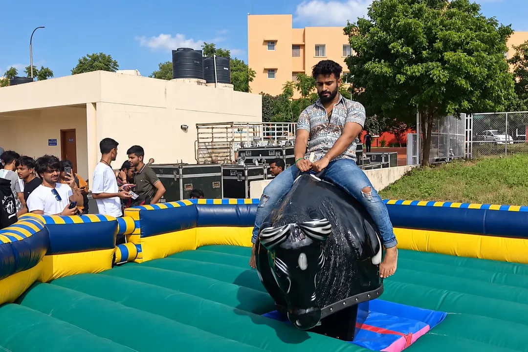 Man riding a mechanical bull inside an inflatable ring