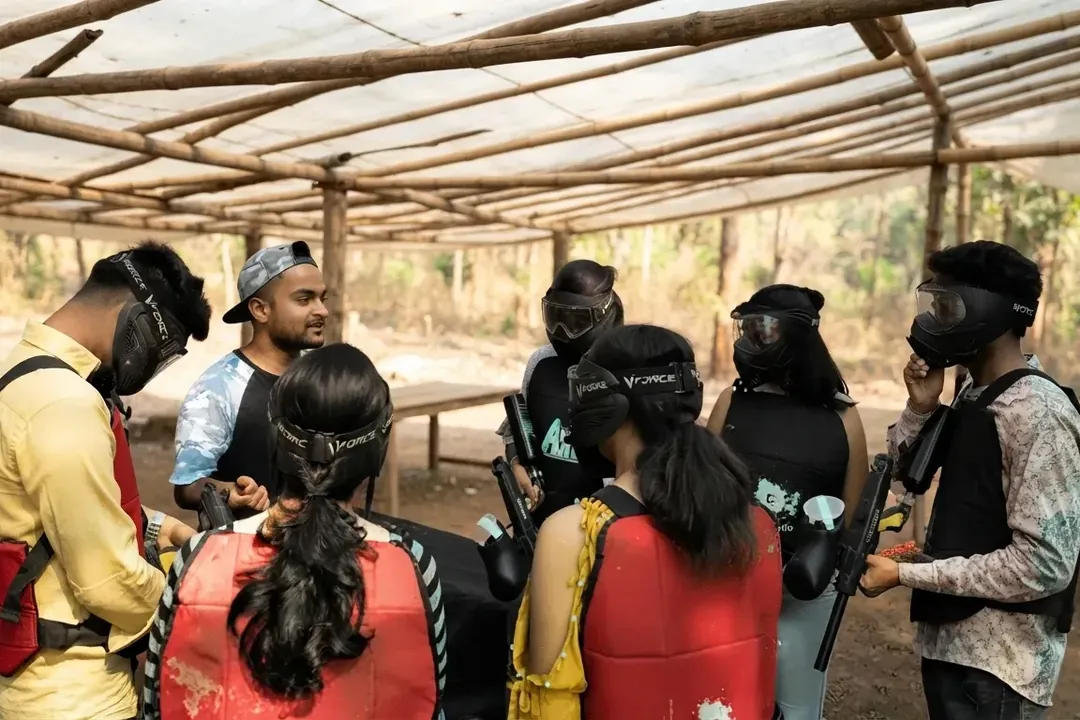 Paintball players listening to a safety briefing