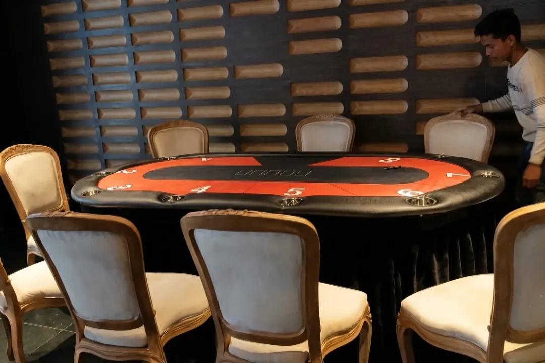 Casino-style poker table with chairs