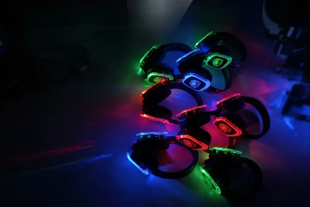Wireless silent disco headphones glowing green, blue and red