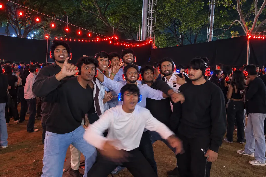 Guests posing at an outdoor silent disco with glowing headphones