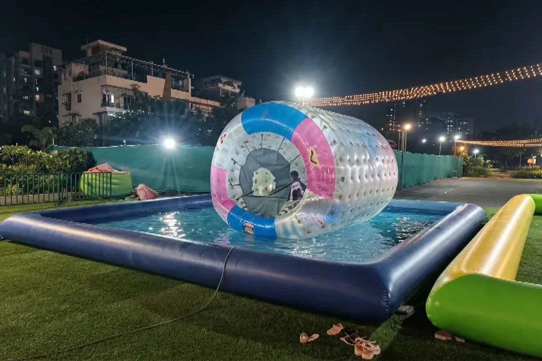 Water zorbing ball floating in an inflatable pool at night